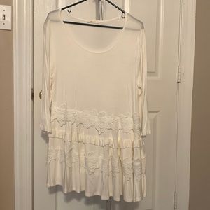 White top. 3/4 sleeve length. Cute ruffle and lace detailing.